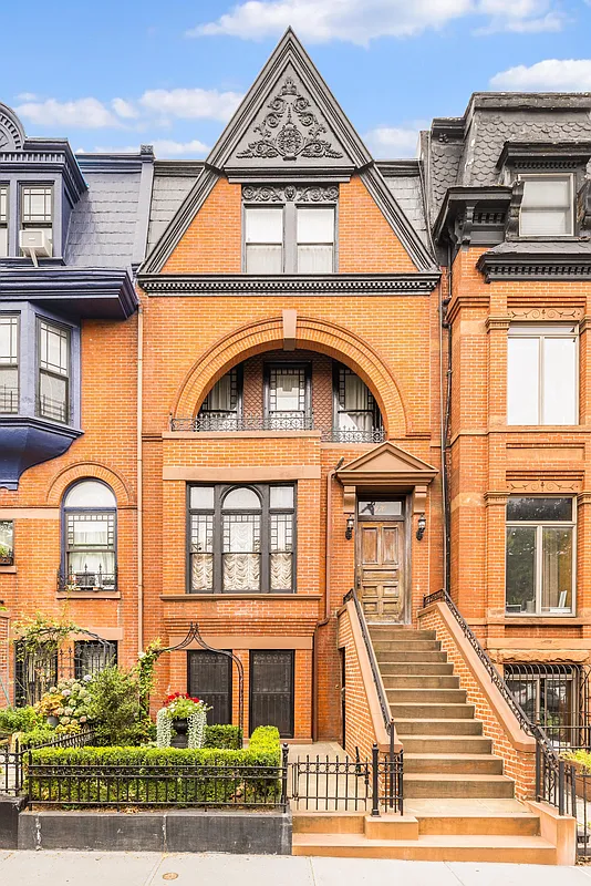 queen anne row house with brick facade