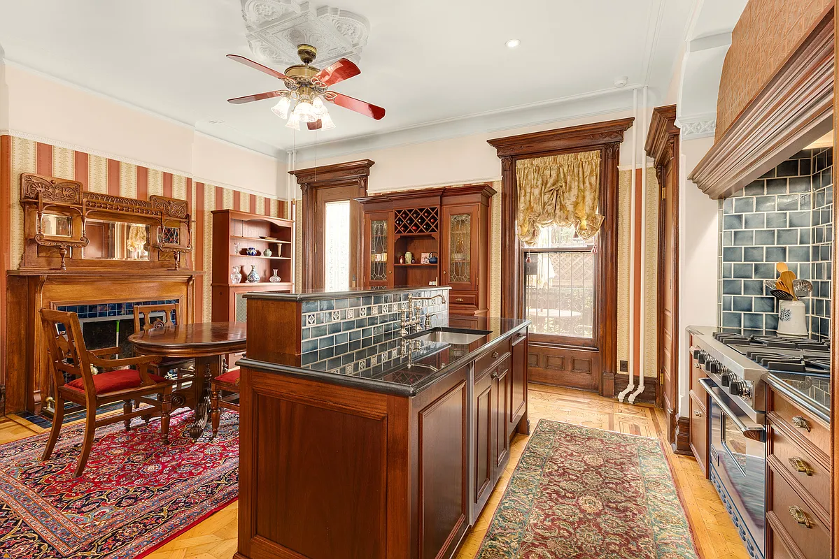 rear parlor with mantel and wood floor and modern kitchen inserted