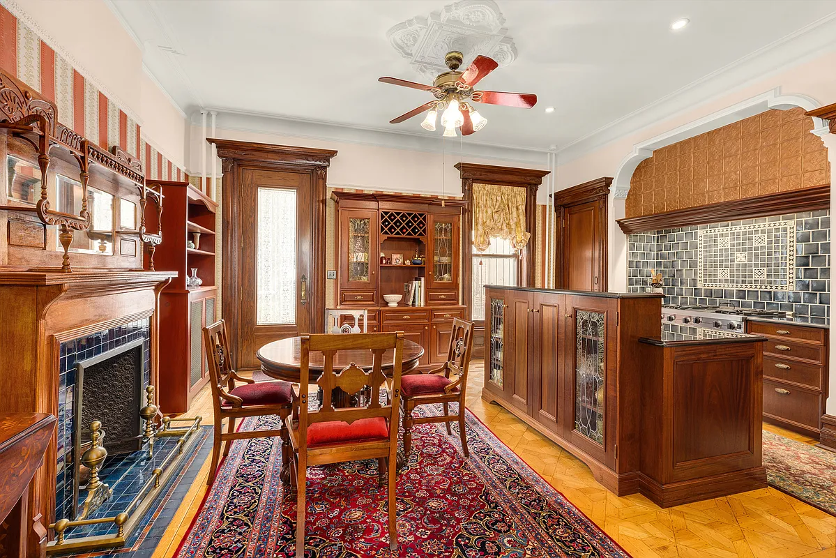 rear parlor with mantel and wood floor and modern kitchen inserted