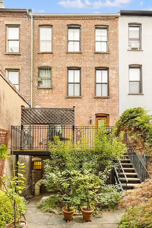brick rear facade wit view of deck and the patio below