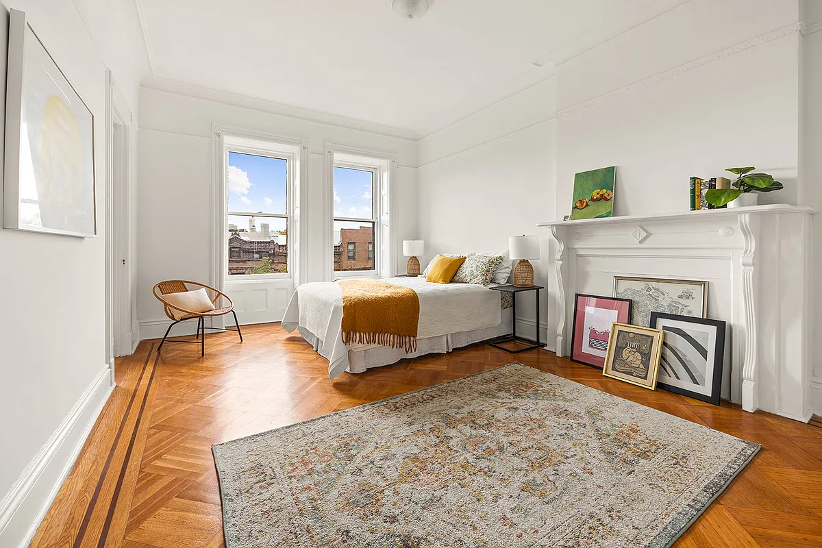 bedroom with white mantel, picture rail
