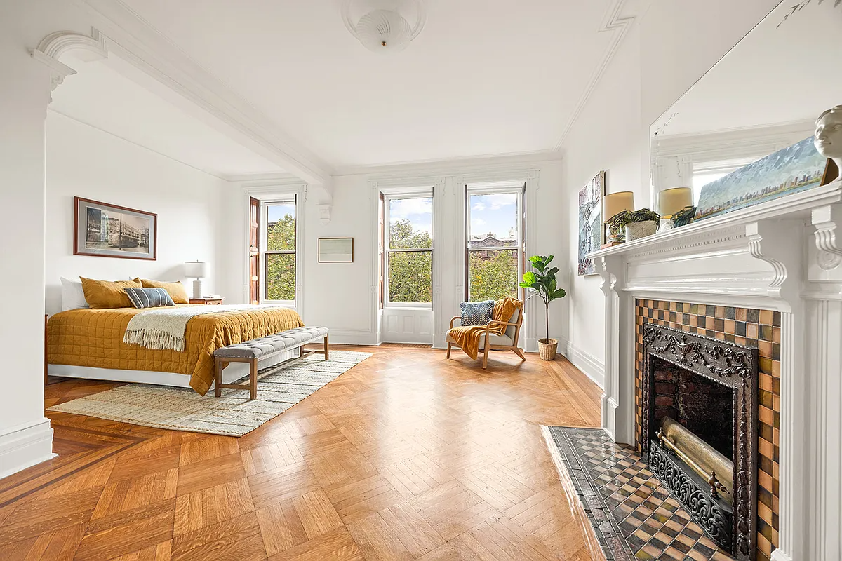 bedroom with white mantel, bed niche