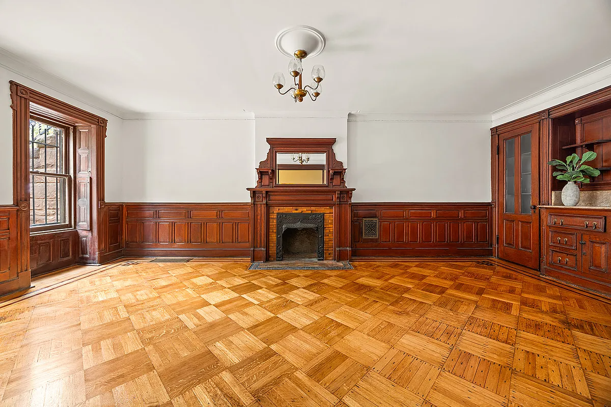 garden level original dining room with wainscoting, built-ins, mantel