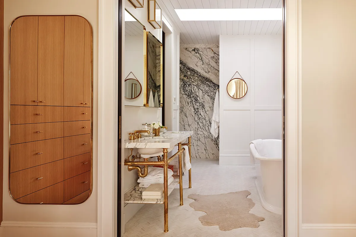 bathroom with skylight and a soaking tub
