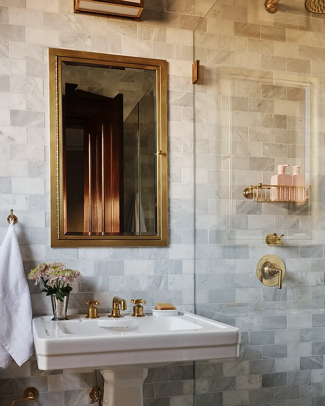 bathroom with white pedestal sink and a glass doored shower