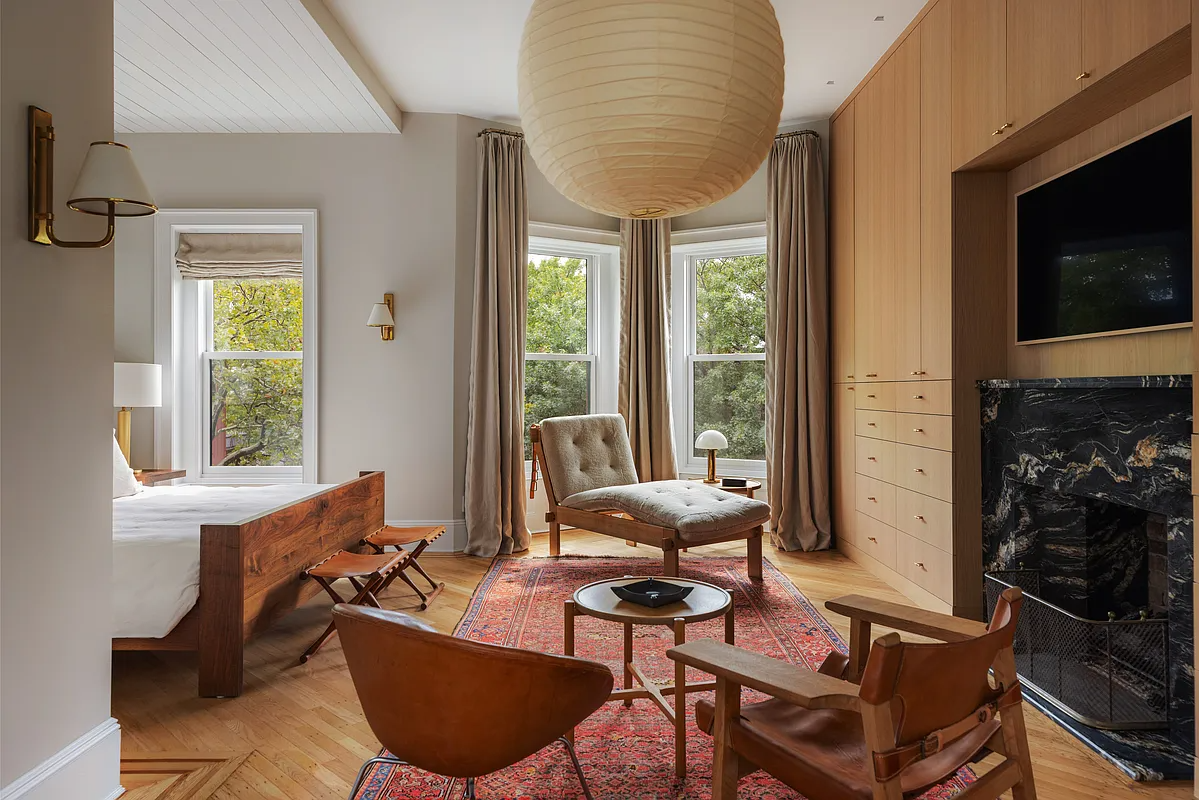 bedroom with modern wall of storage with a black marble mantel