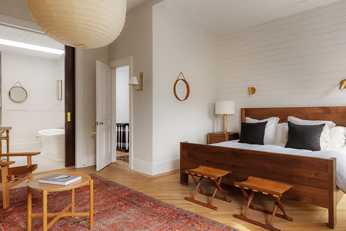 bedroom with pocket doors to en suite bath with soaking tub