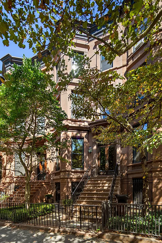 angled bay brownstone shaded by trees