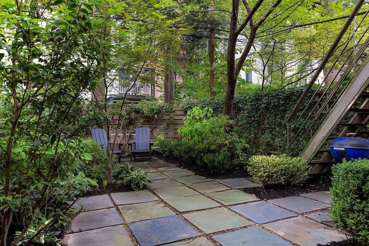 garden with paved patio, stairs from desk, and planting beds