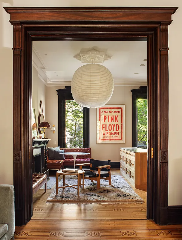pocket doors leading to rear parlor with mantel and modern kitchen