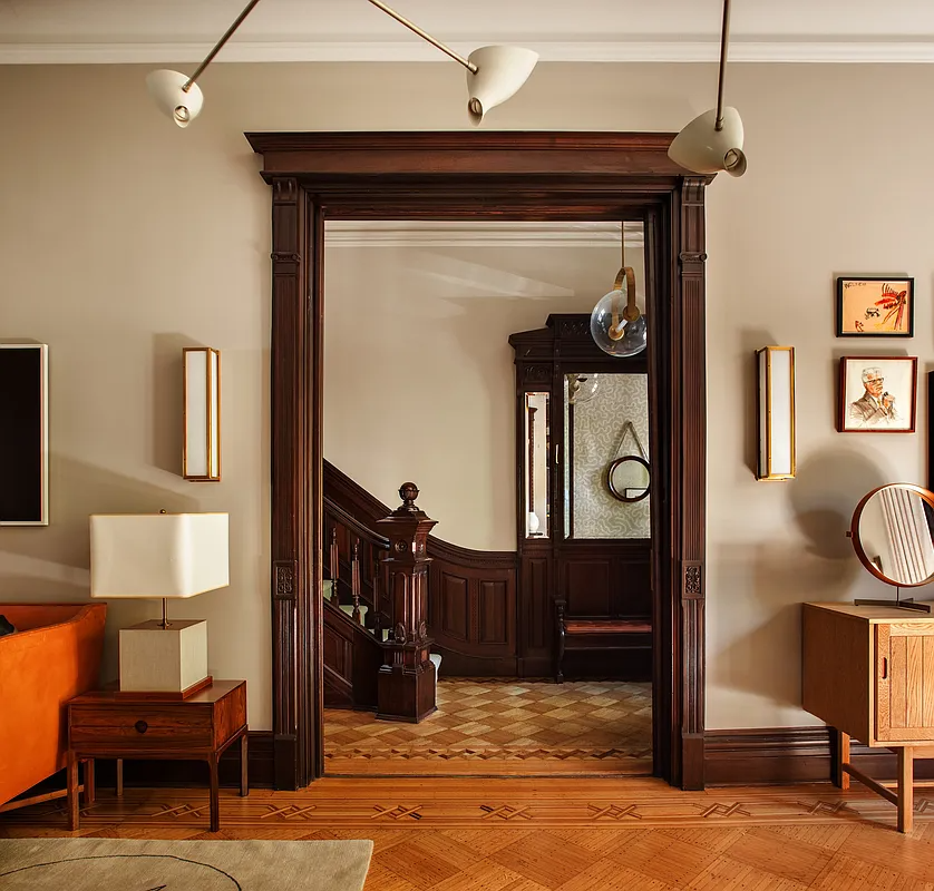 original wood door surround in parlor with view into entry hall with stair and mirror