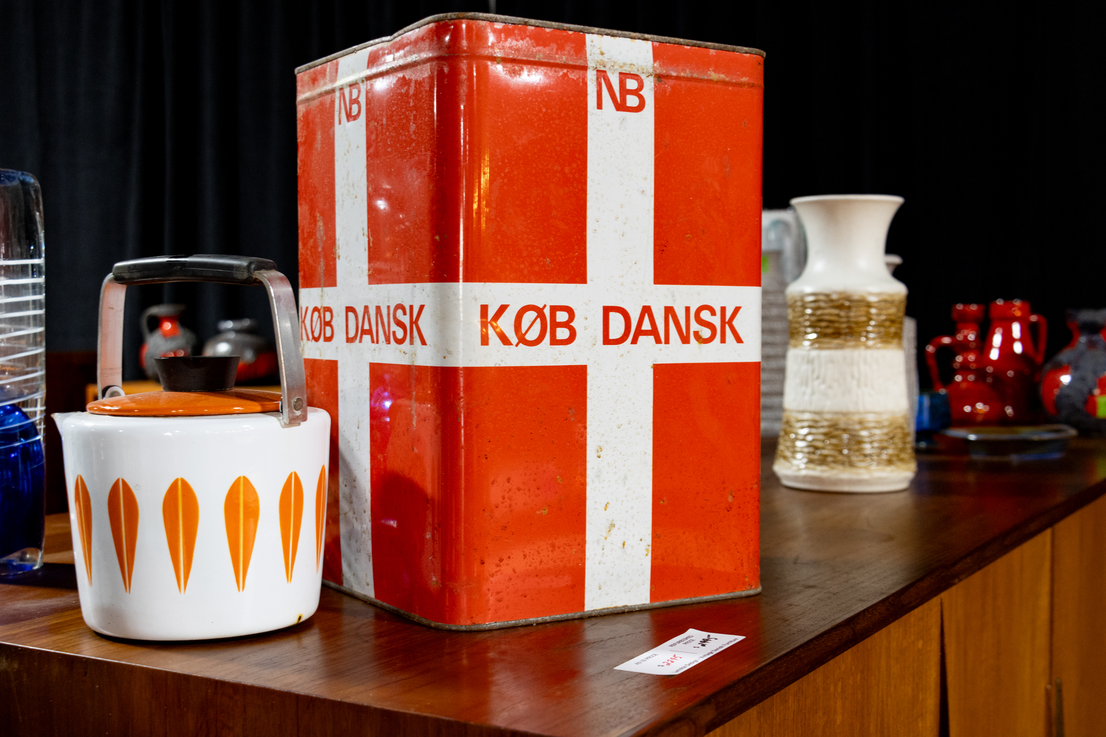 tin with a white cross on it