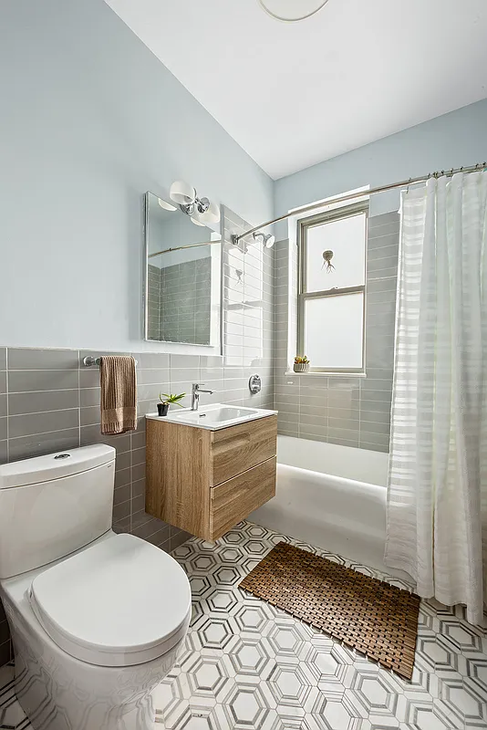 bathroom with floating vanity, white fixtures