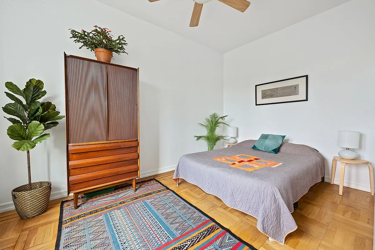 bedroom with ceiling fan, wood floor