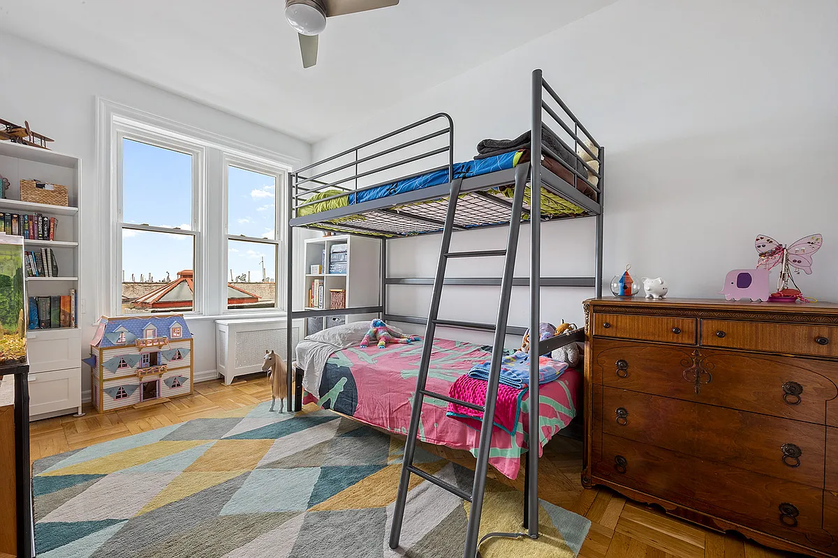 bedroom with wood floor, ceiling fan, room for bunkbeds
