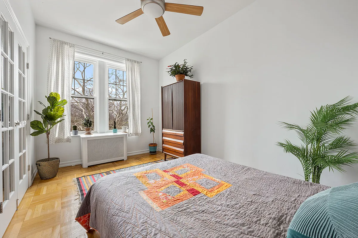 bedroom with French doors, ceiling fan, wood floor