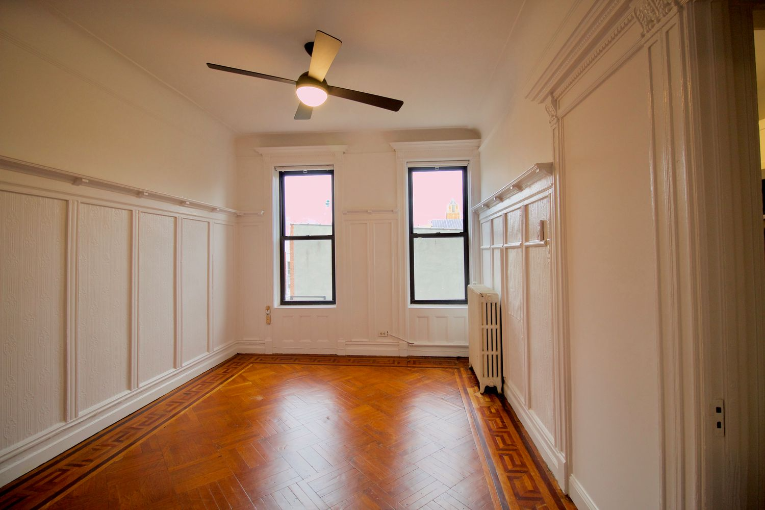 original dining room with wainscoting, plate shelf and wood floor