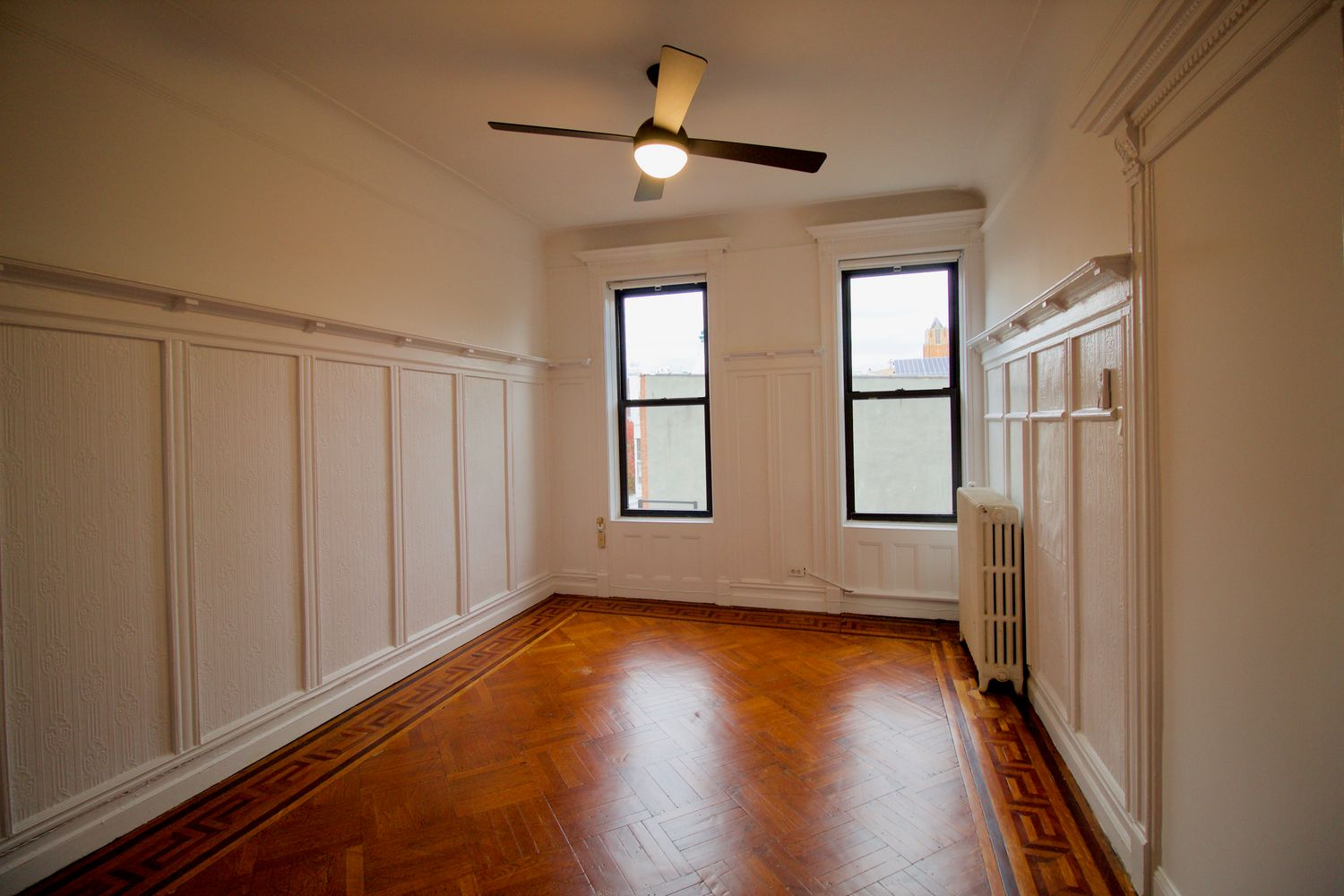 original dining room with wainscoting, plate shelf and wood floor