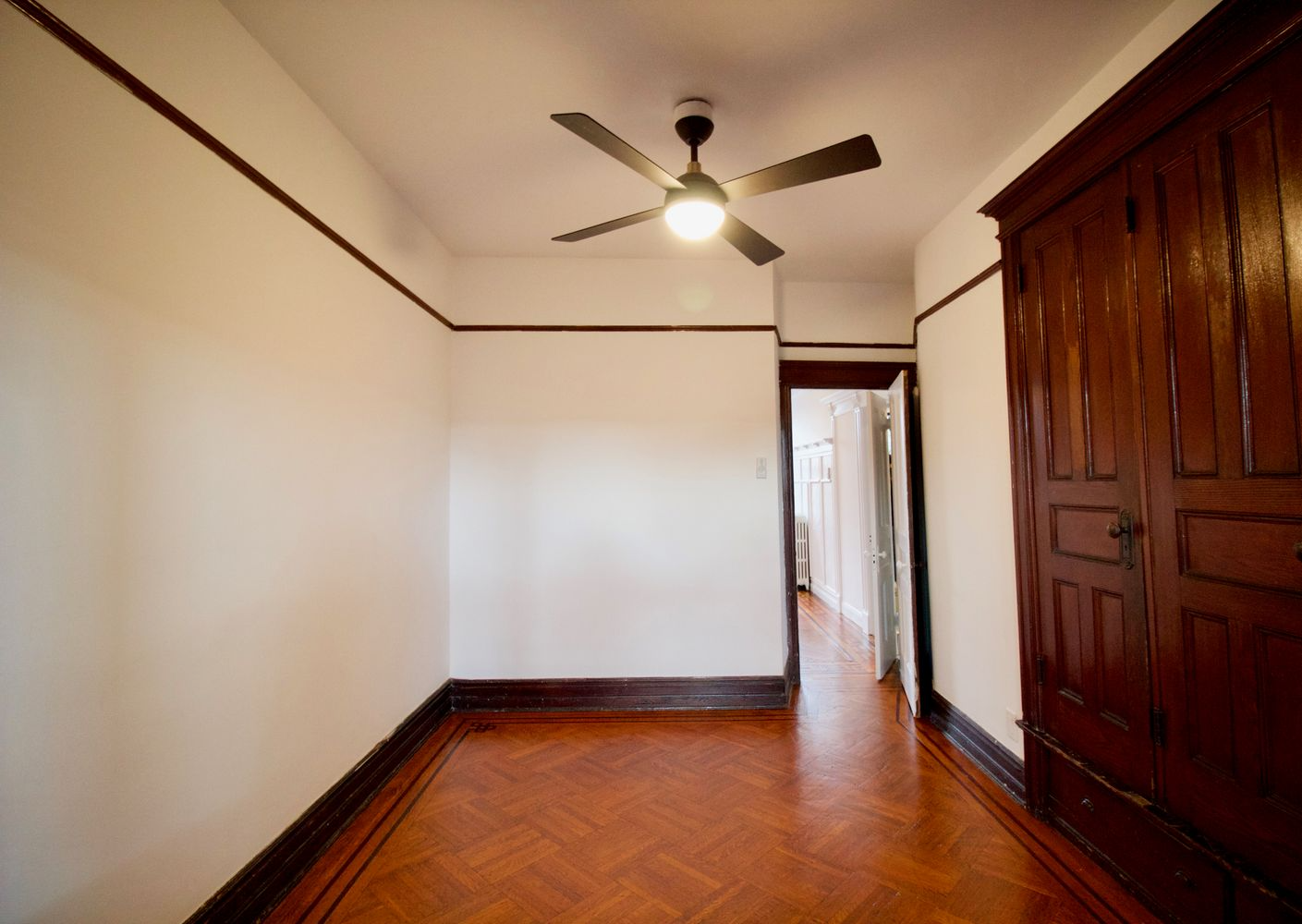 middle parlor with wood floor, built-in storage
