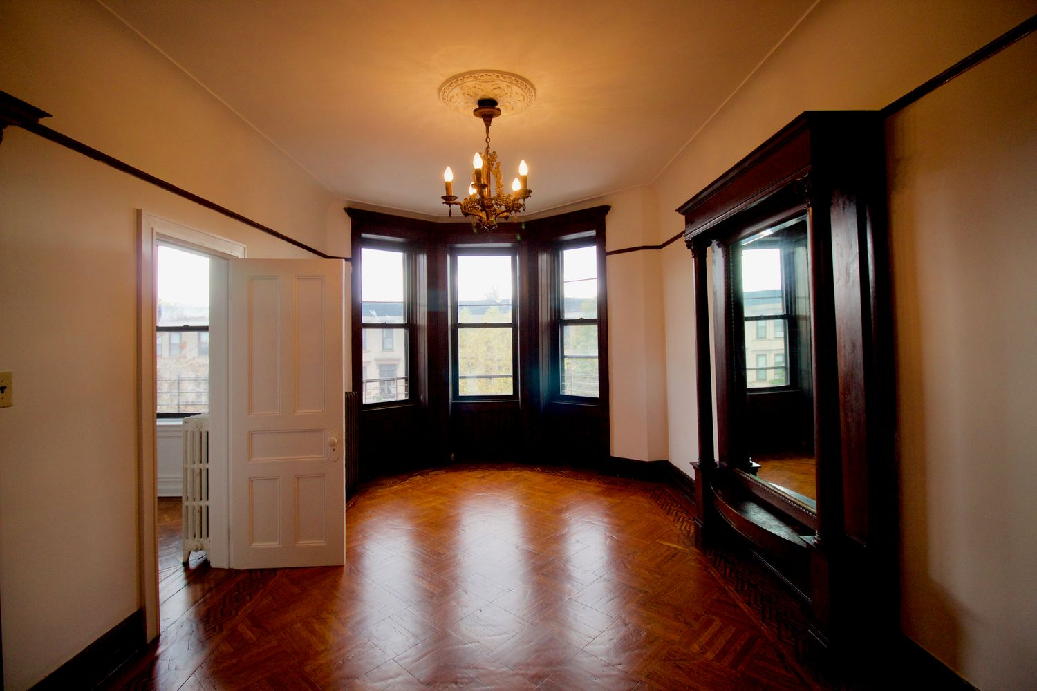 parlor with wood floor, pier mirror