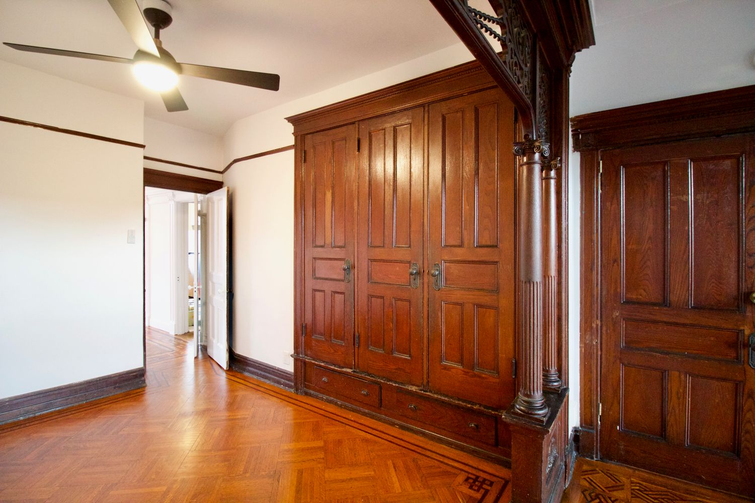 middle parlor with wood floor, built-in storage