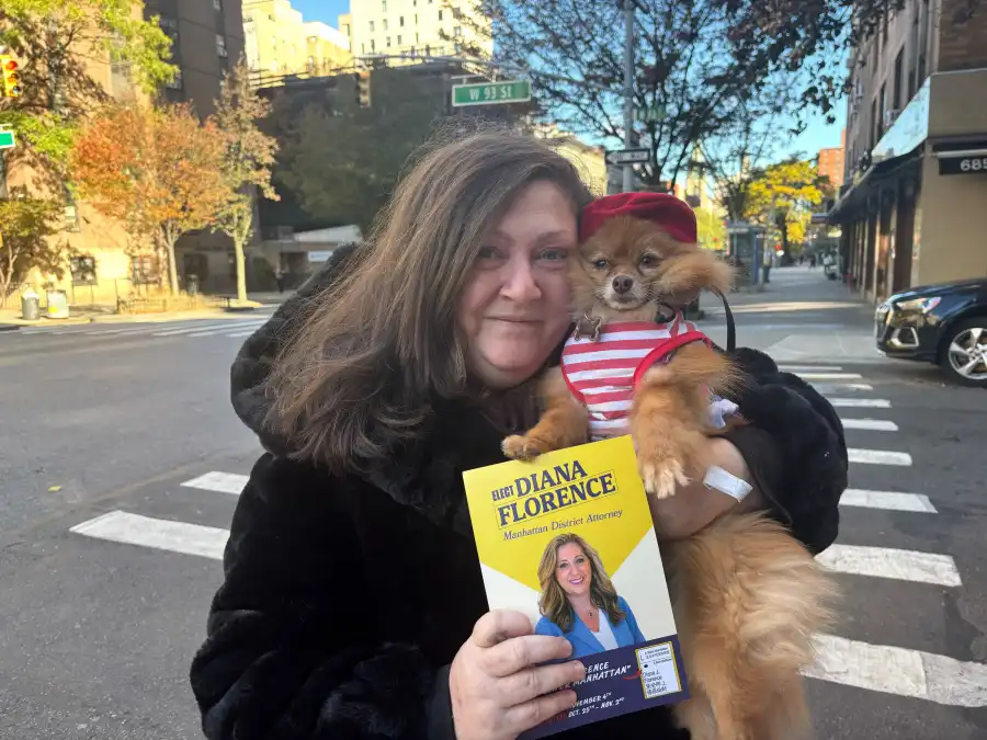 woman holding a dog in a striped sweater