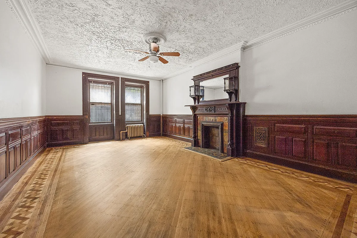 dining room with wainscoting, a mantel