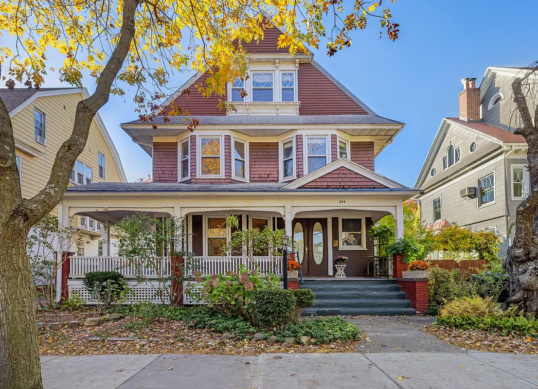 a standalone house with a wraparound porch