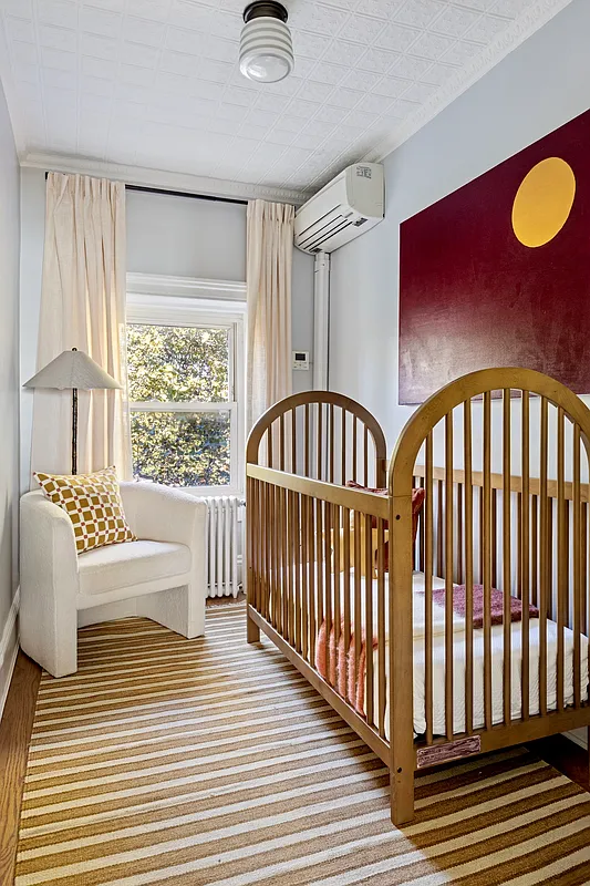 narrow bedroom set up as a nursery