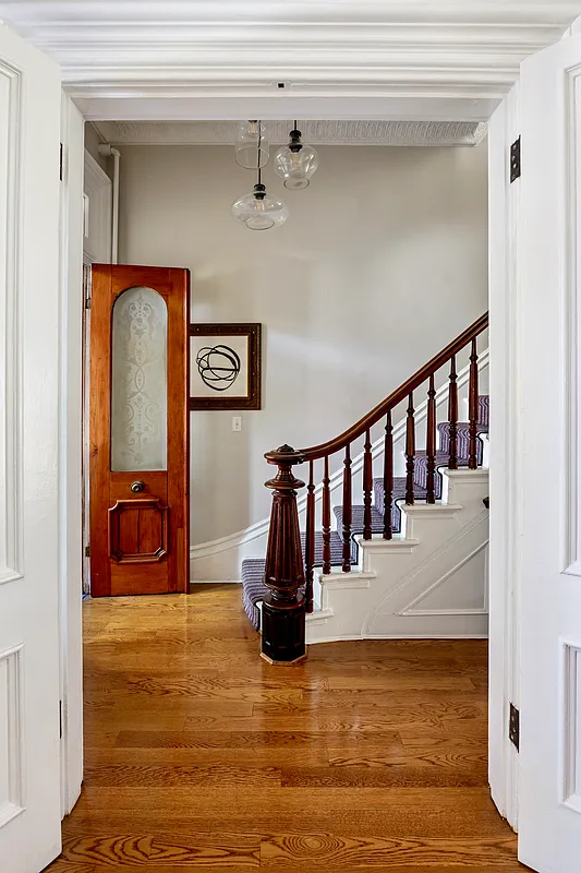 entry with original stair with wooden newel post