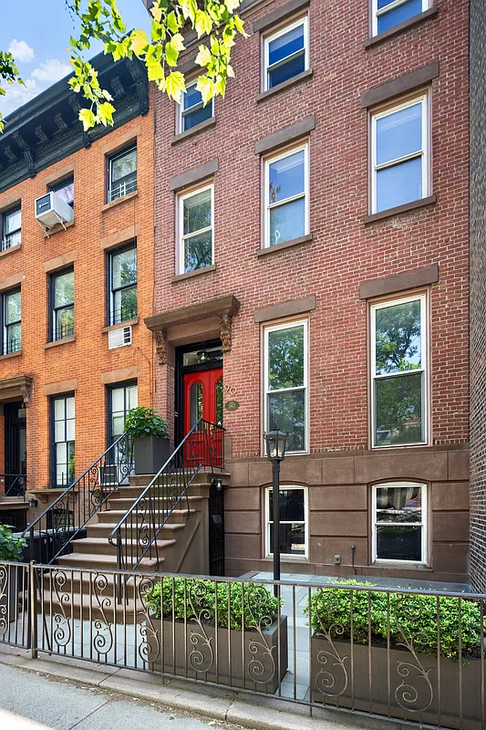 rowhouse with brick exterior with brownstone trim