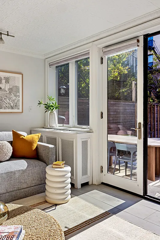 garden level living room with wall of glass and view to rear yard