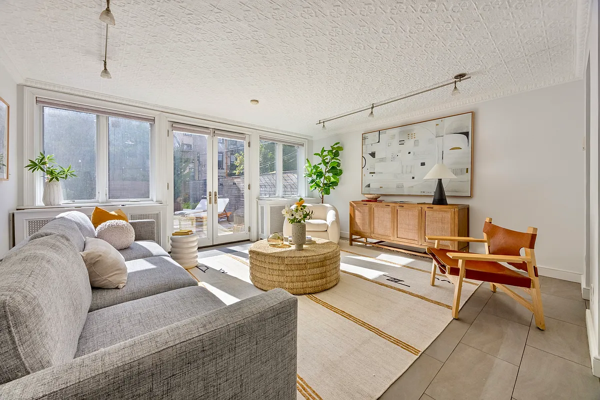 garden level living room with tile floor, wall of glass