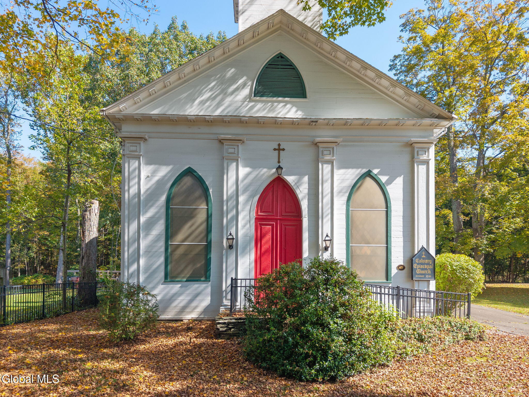 wood frame church with pilasters and gothic windows