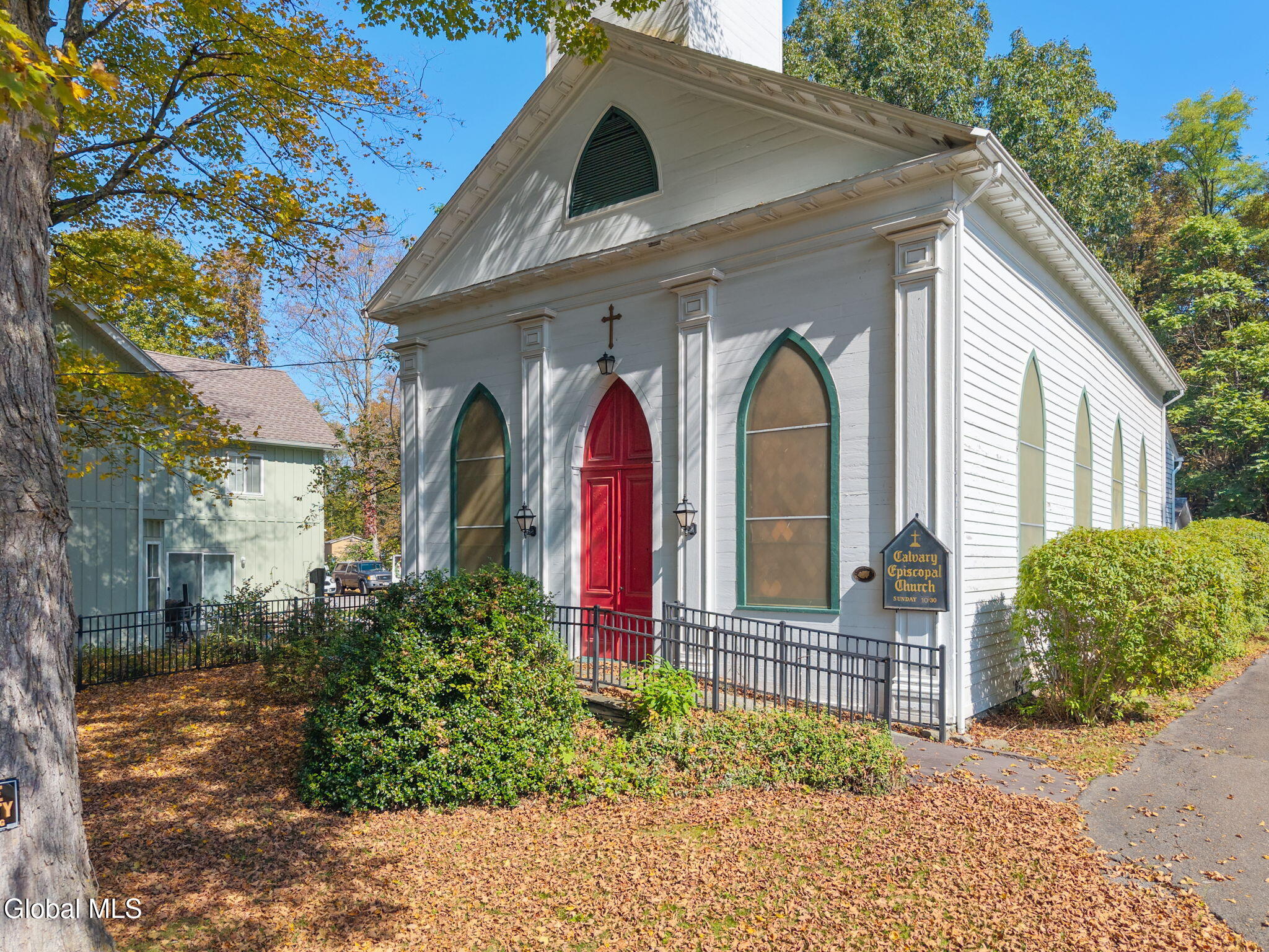 wood frame church with pilasters and gothic windows