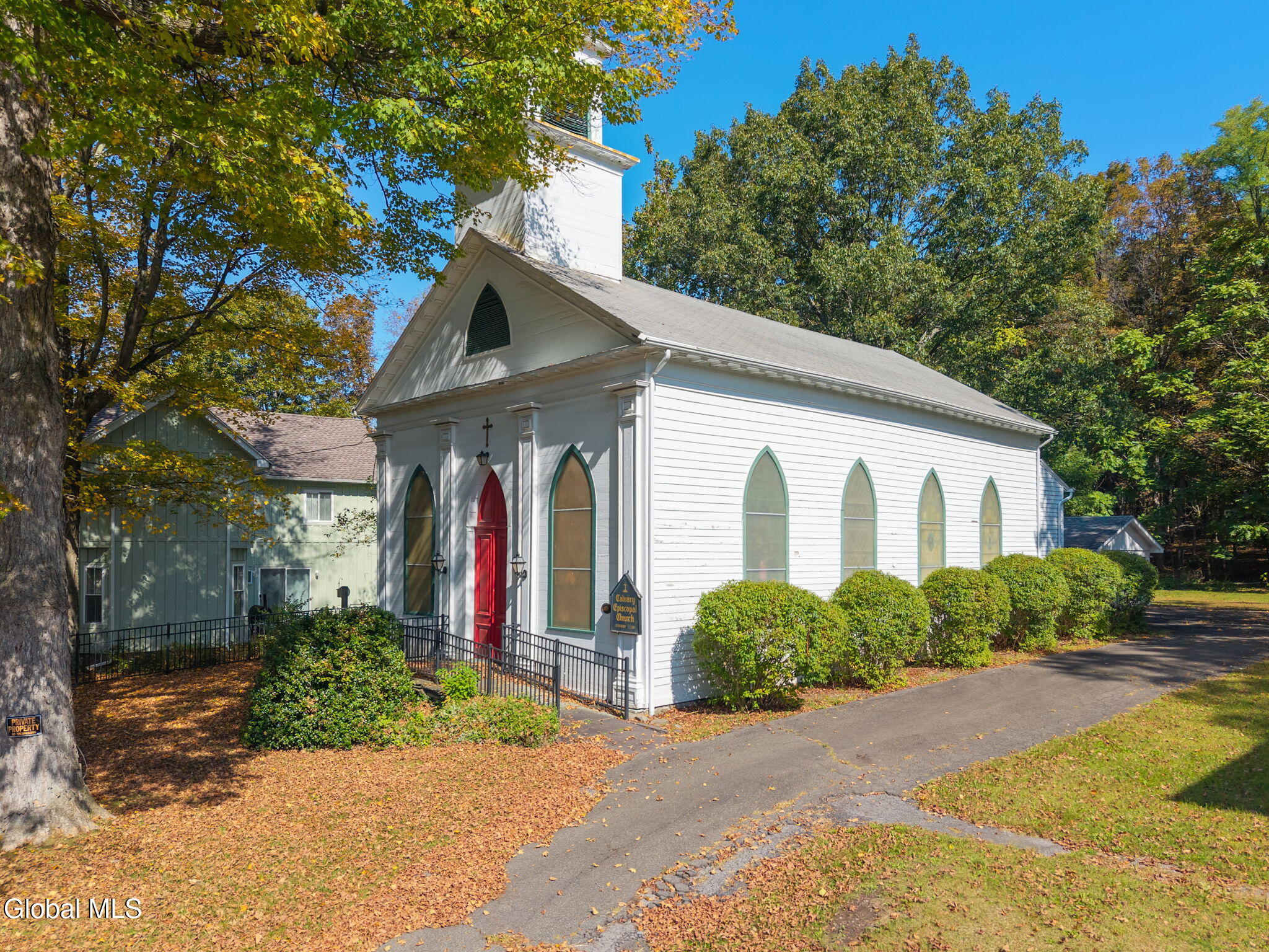 wood frame church with pilasters and gothic windows