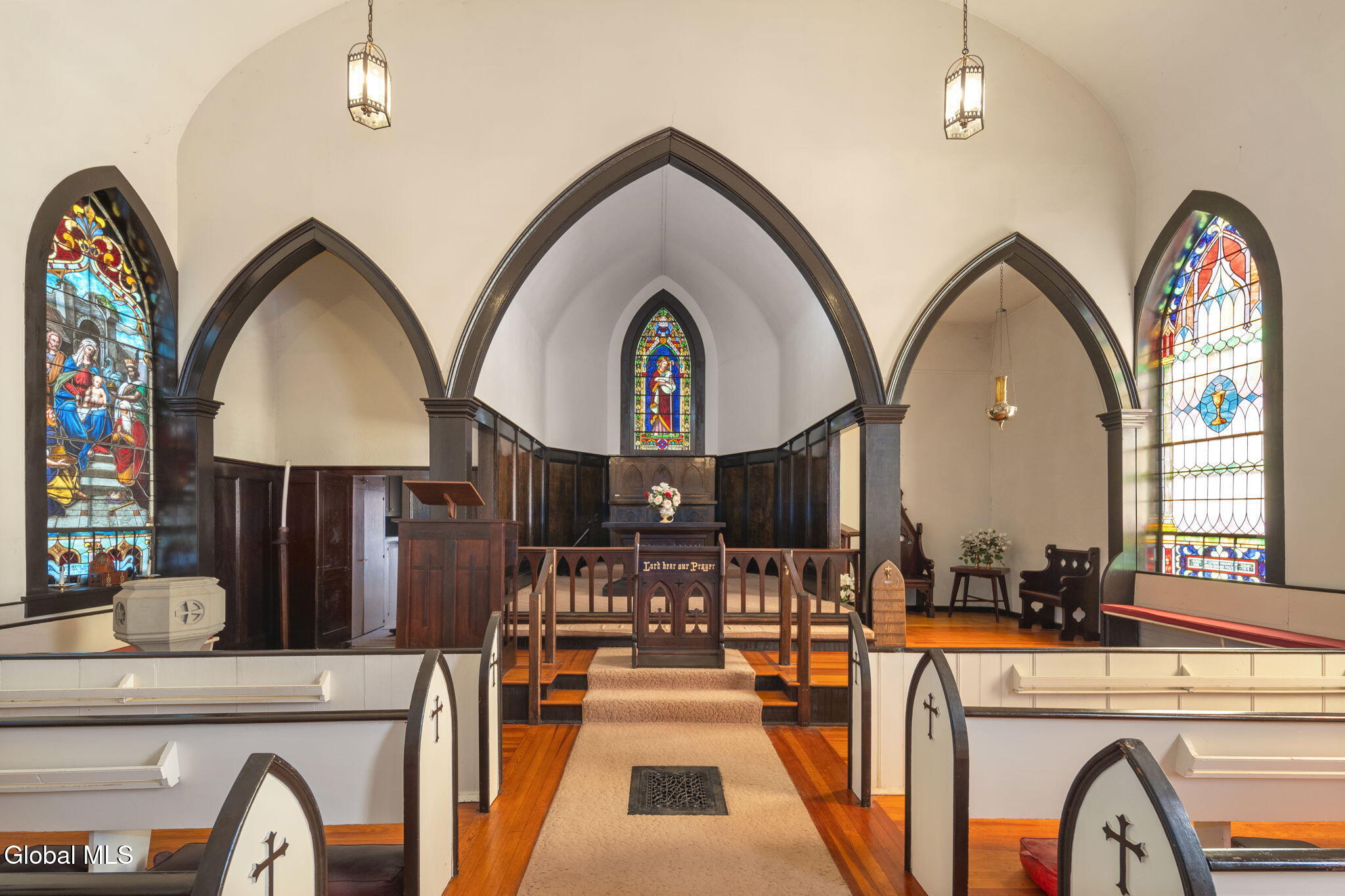 church interior with pews and stained glass windows