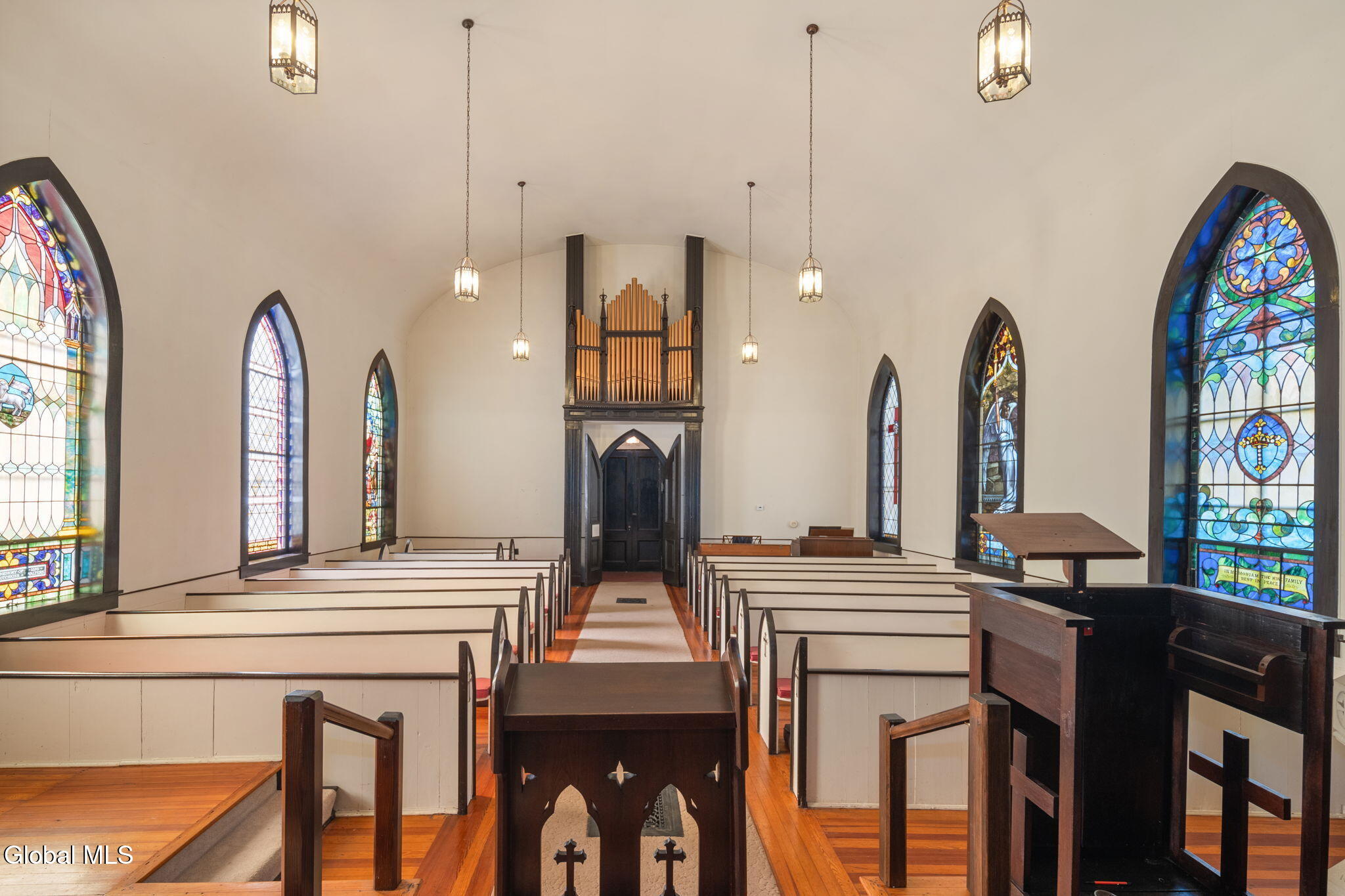 church interior with pews and stained glass windows