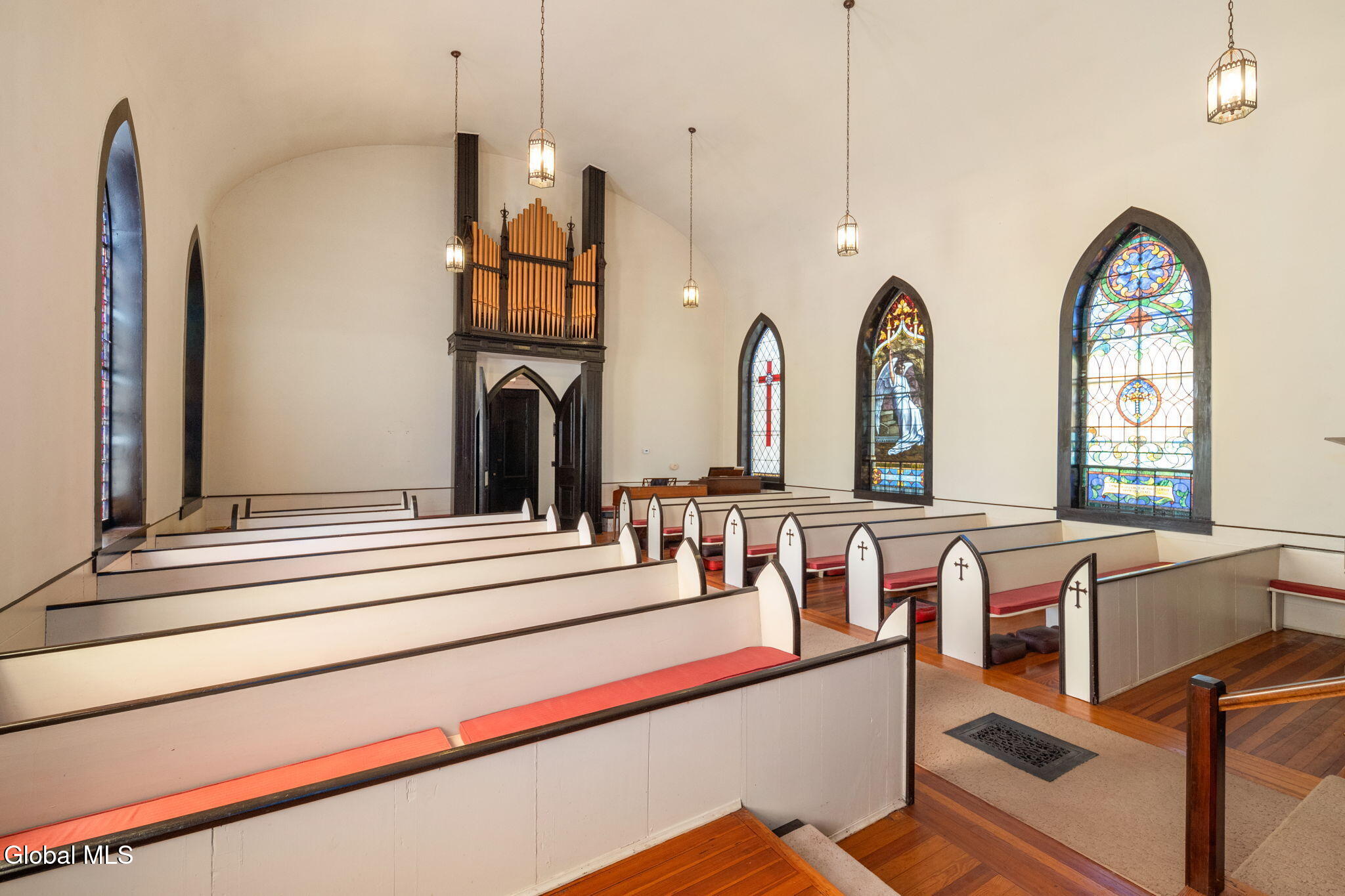 church interior with pews and stained glass windows