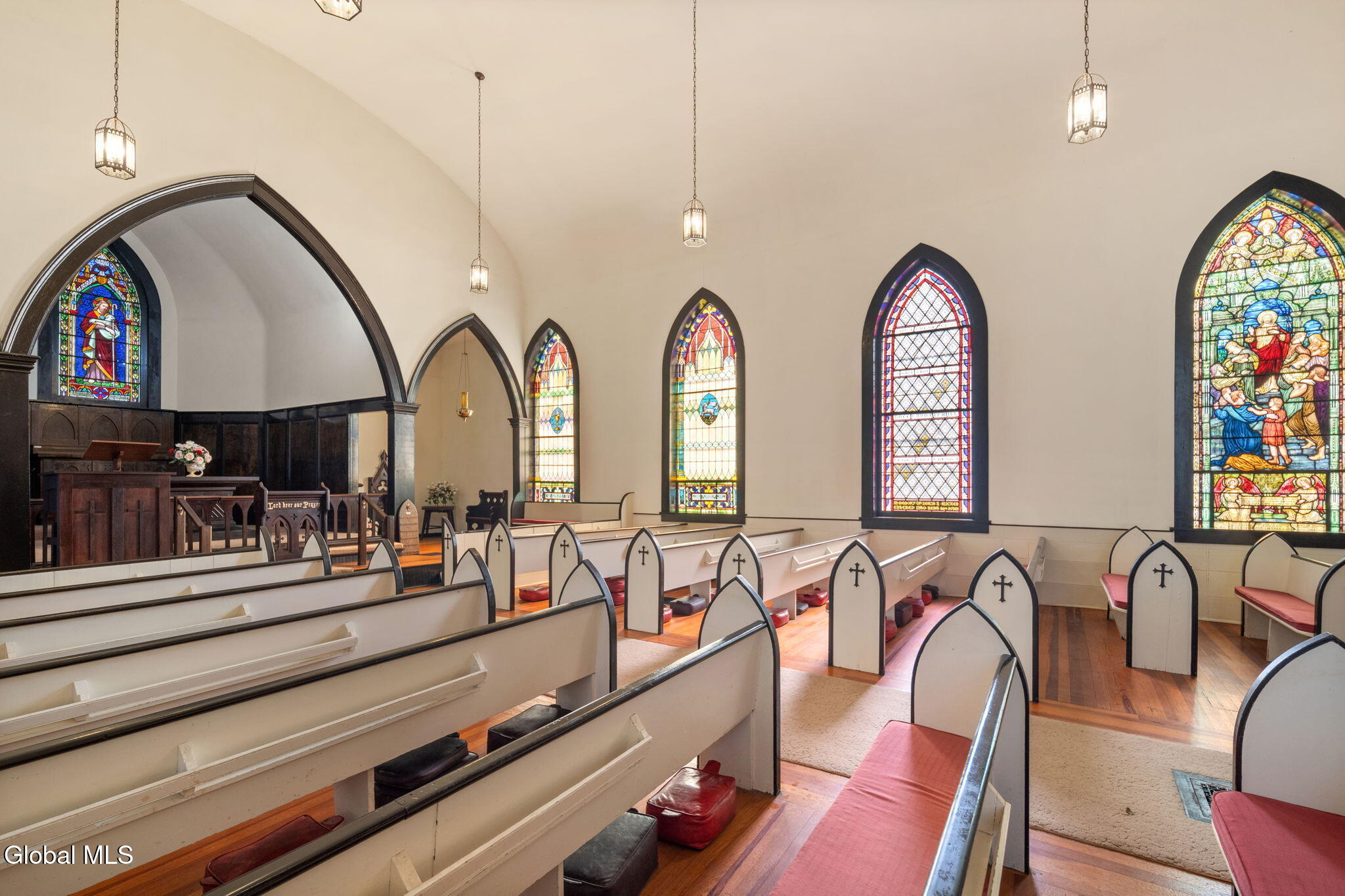 church interior with pews and stained glass windows