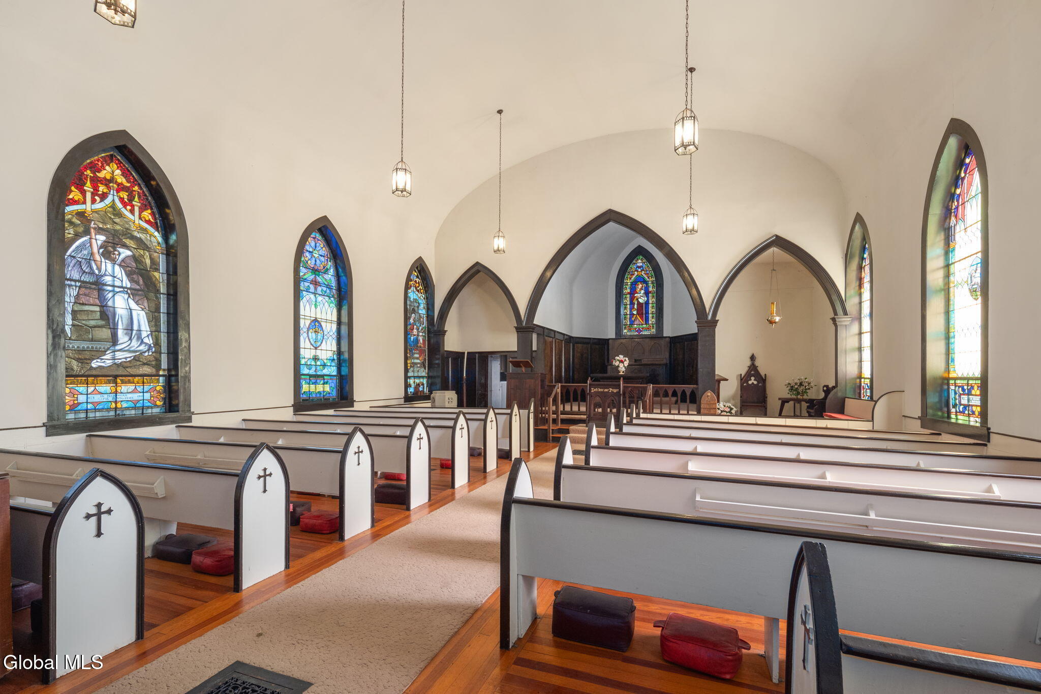 church interior with pews and stained glass windows