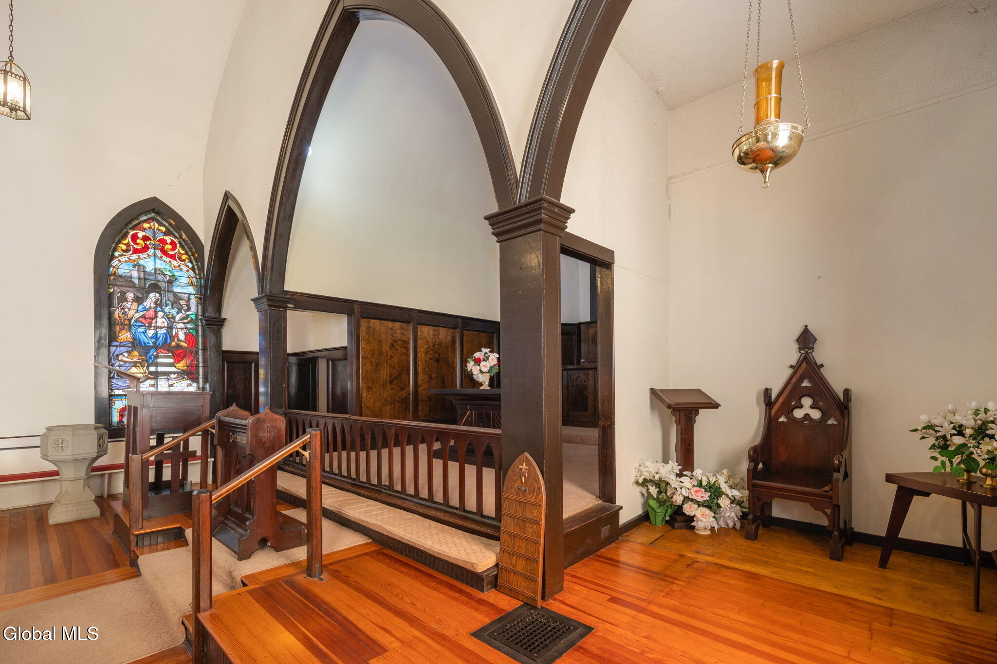 church interior with pews and stained glass windows