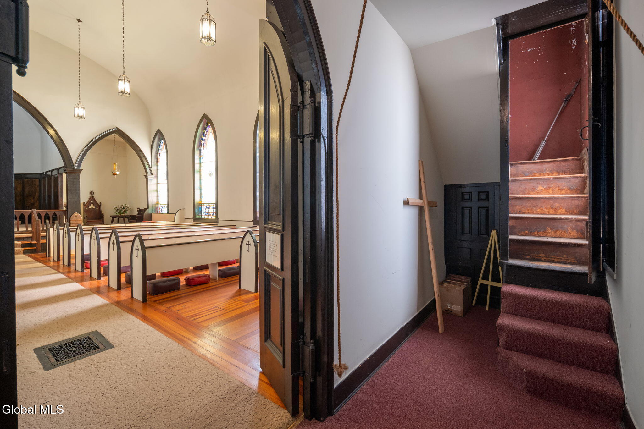 church interior with pews and stained glass windows