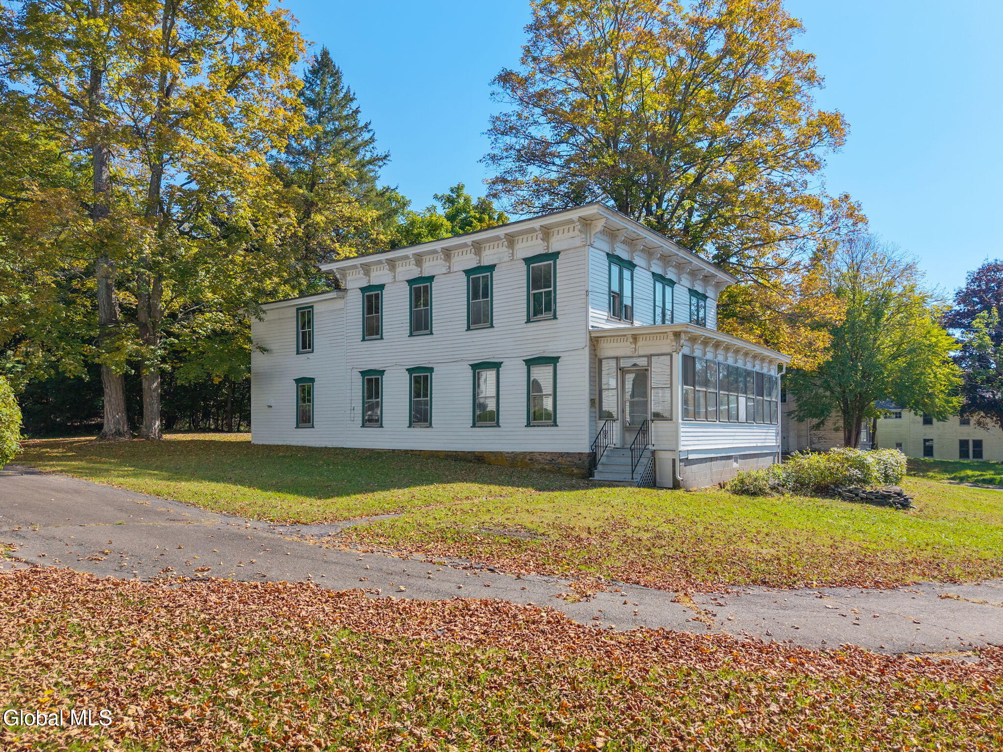 wood frame rectory with green trim