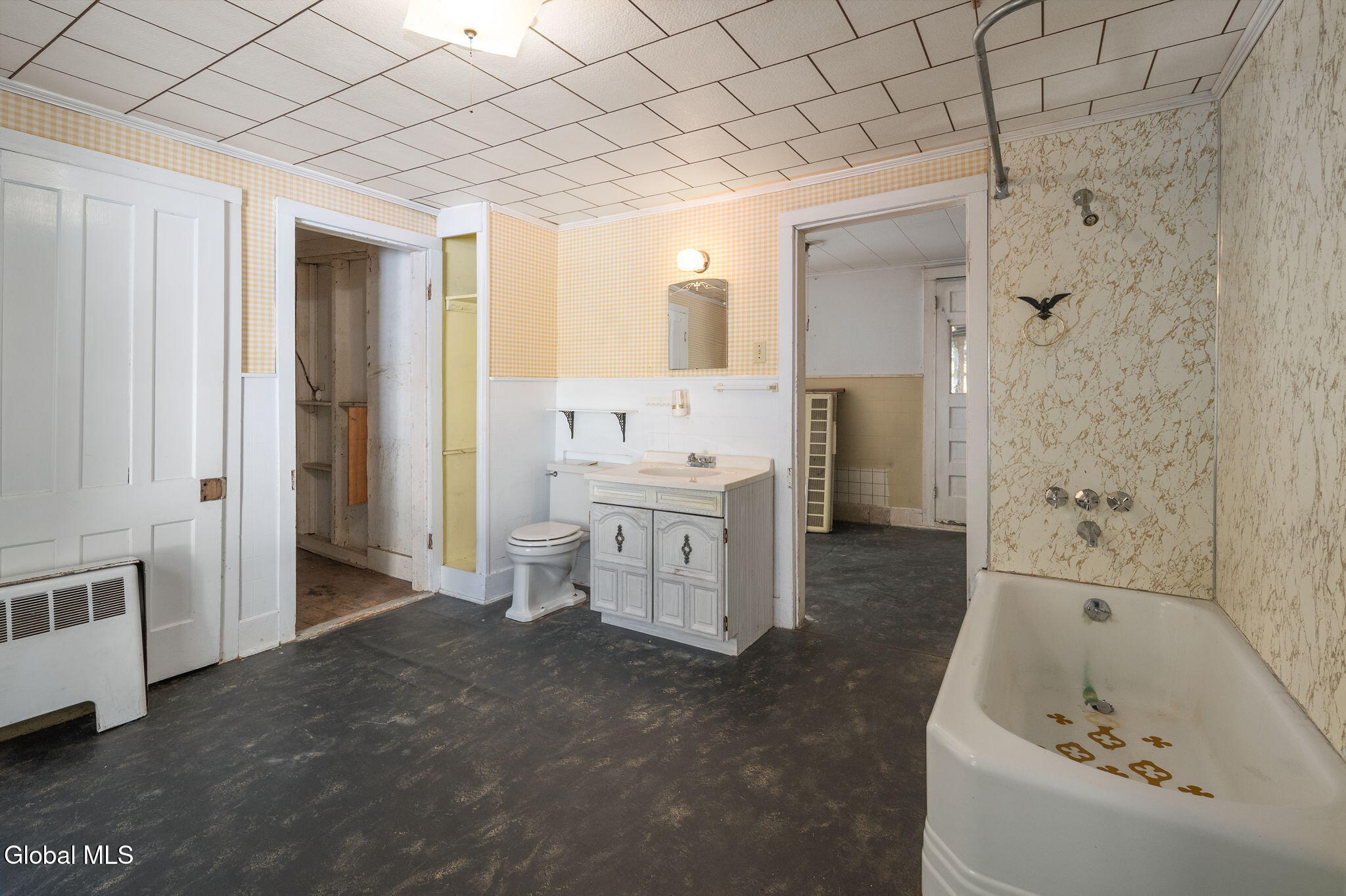 bathroom with white fixtures, dropped ceiling