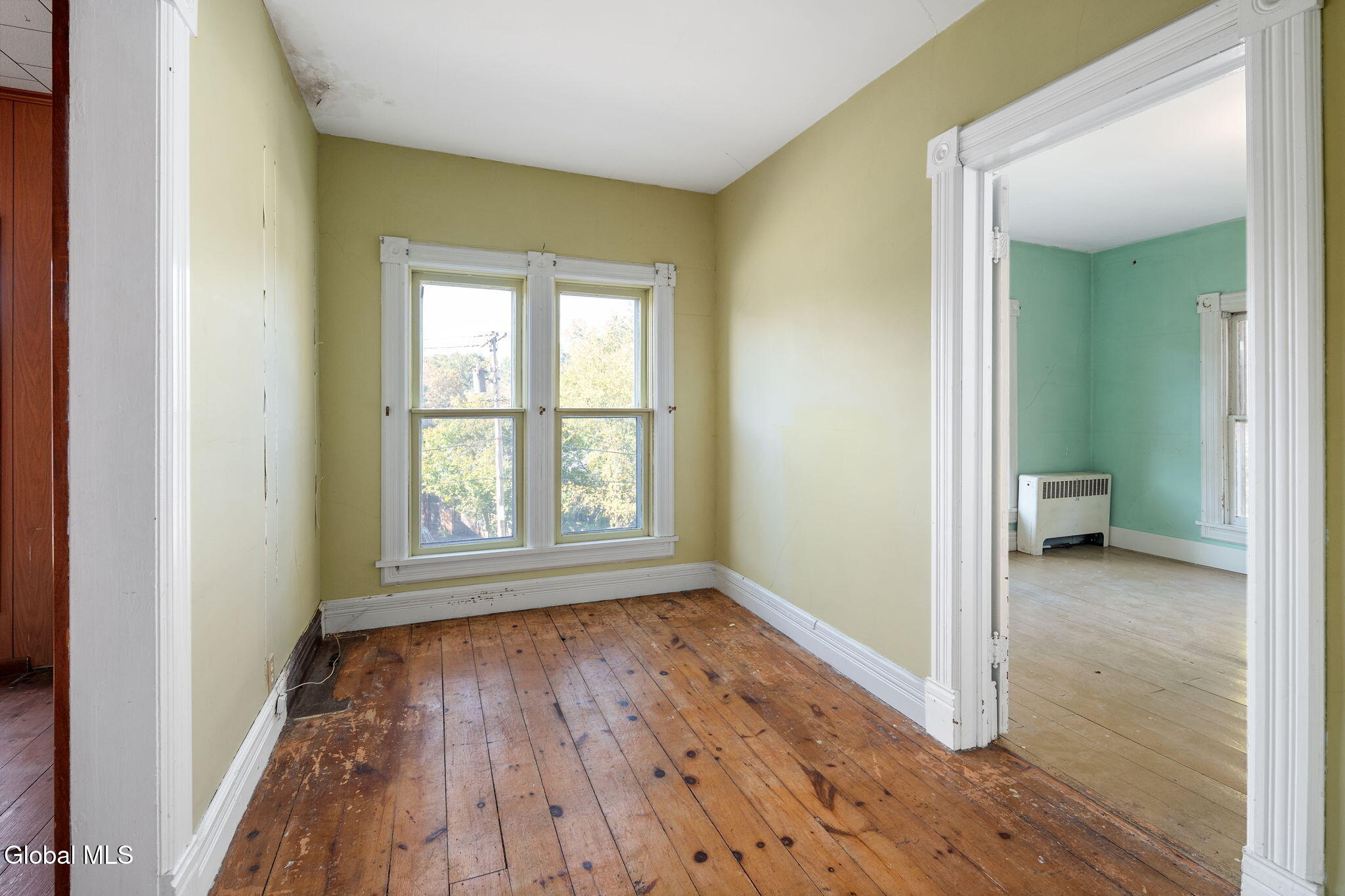 upstairs hall with unpainted floorboards, trim with corner blocks