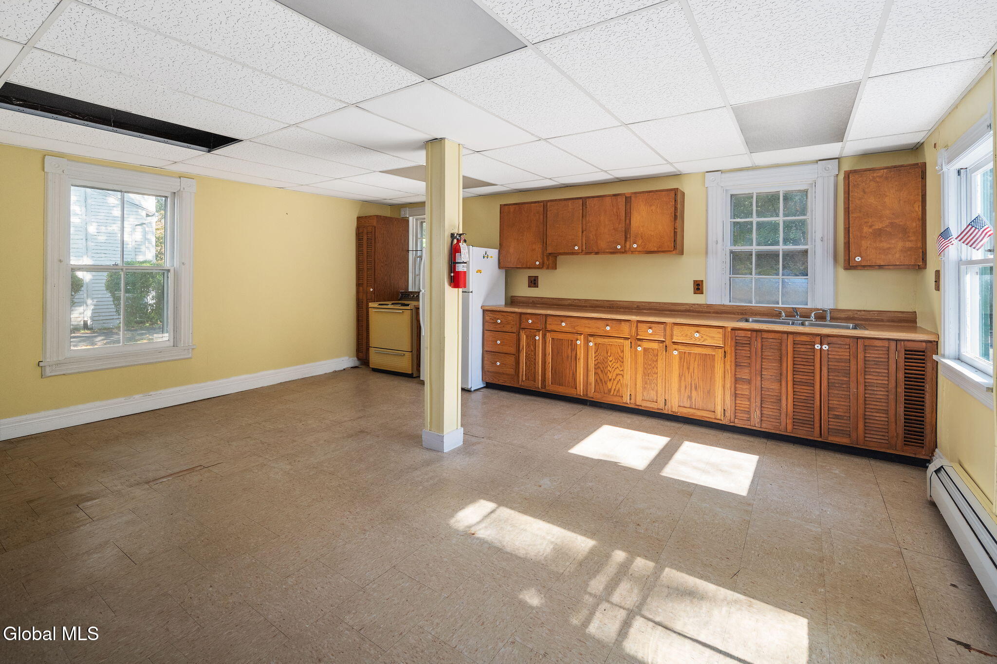 kitchen with wood cabinets, dropped ceiling