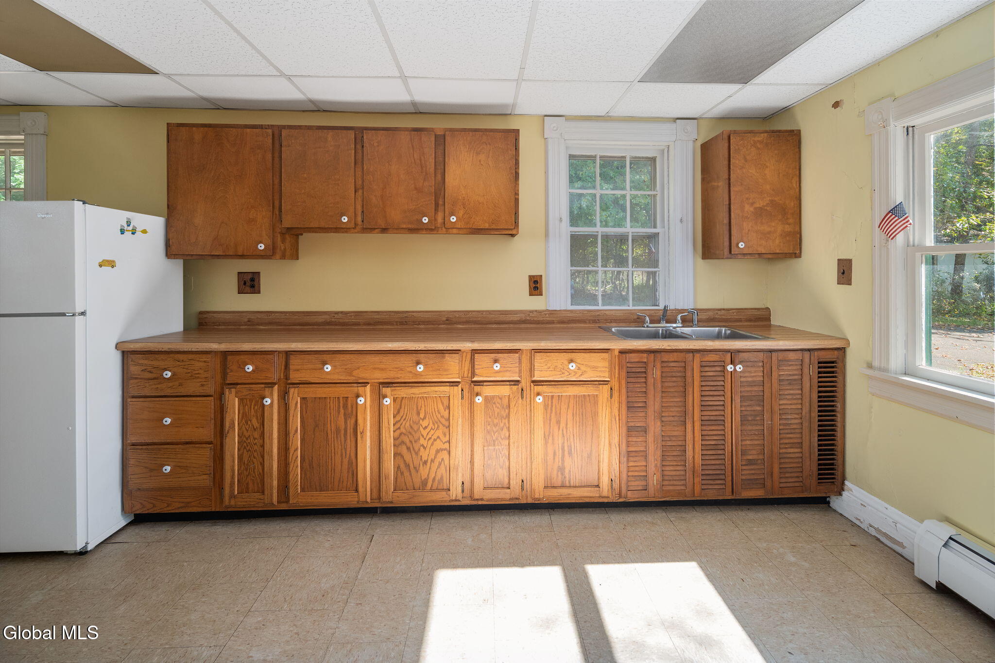 kitchen with wood cabinets, dropped ceiling