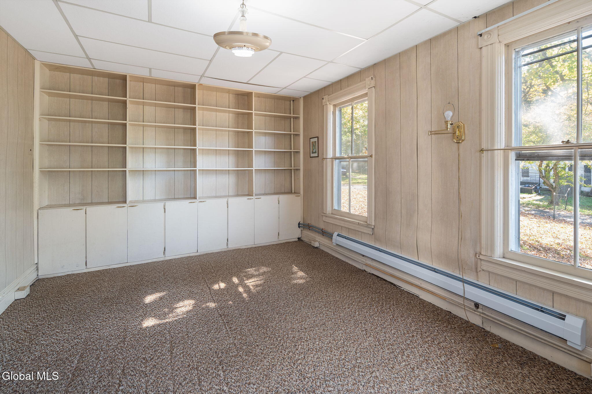 office with paneling and built-in shelves
