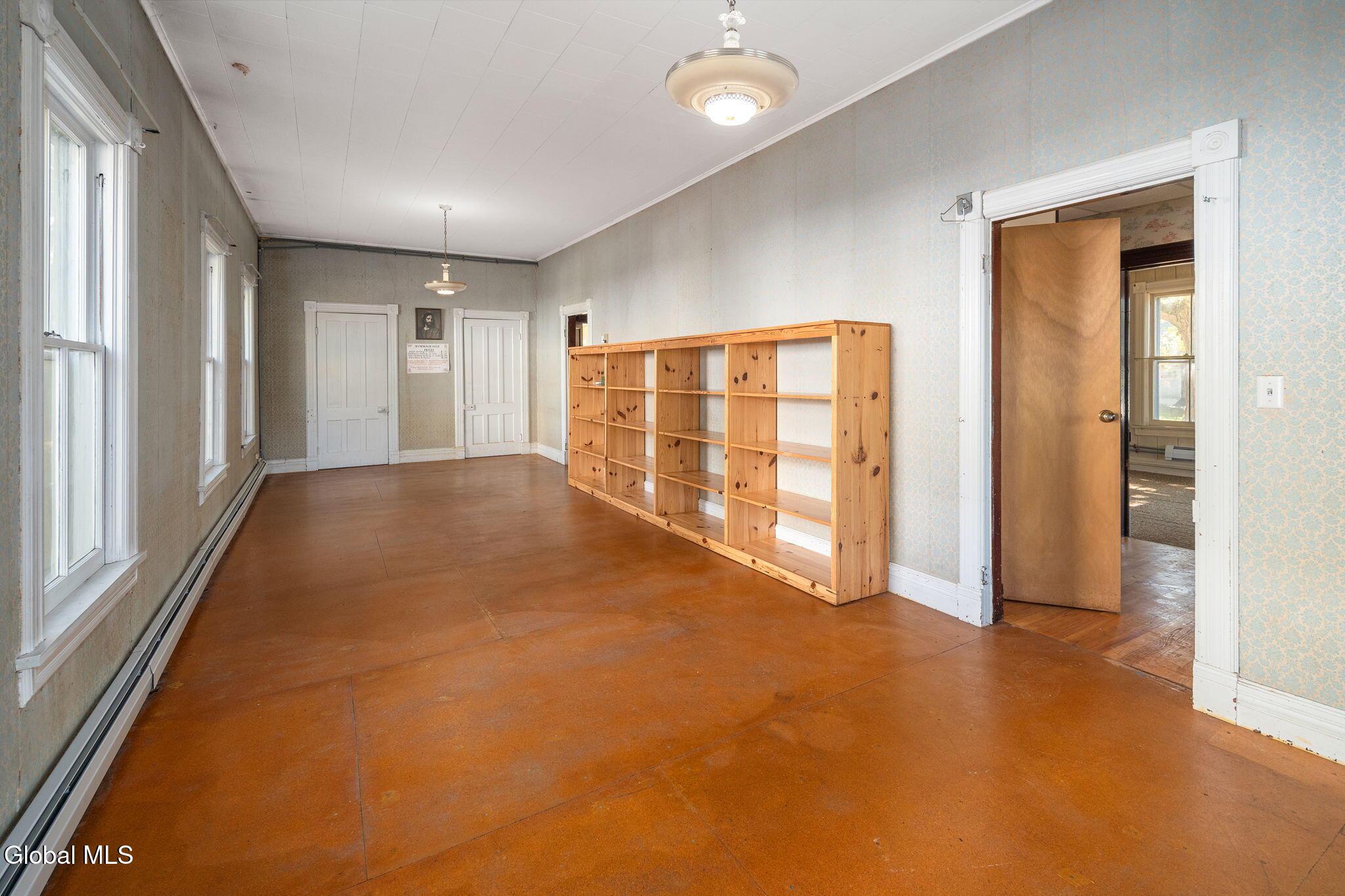 living room with wallpaper and baseboard heating